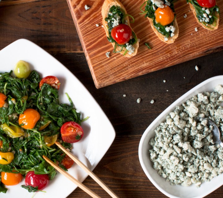 close-up-of-sauteed-arugula-and-cherry-tomatoes-crostinis-with-blue-cheese-crumbles-1929-2